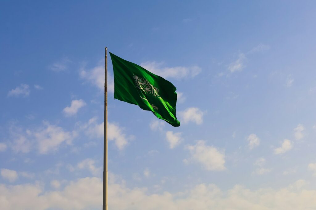 Saudi Arabia national flag waving in sky - Saudi National Day